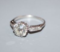 A mid 20th century white metal and single stone diamond ring, with diamond set shoulders, the old