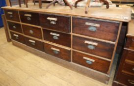 A Victorian oak and mahogany twelve drawer shop counter L.220cm