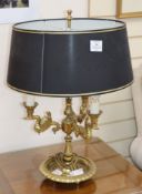 A brass lamp, with black and gold shade