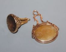 A Victorian yellow metal and chalcedony spinning fob seal and a 1960's 9ct gold and gem set seal.