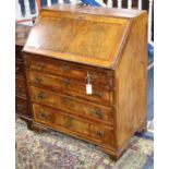 A George III style figured walnut bureau W.81cm