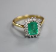 A modern 18ct gold, emerald and diamond set rectangular cluster ring, size L.