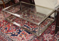 A Maison Jansen style glass two tier table W.126cm