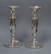 A pair of moder silver candlesticks, on circular bases weighted, 17cm.