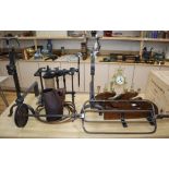 A wrought iron spit, an oak whip rack and a pair of andirons and a leather jug