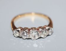 An 18ct and graduated five stone diamond half hoop ring, size L.