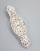 A lady's white metal (stamped 'platinum') and diamond set manual wind cocktail watch (no strap),