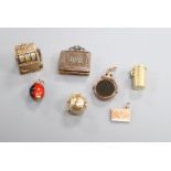 Seven assorted charms, including a 9ct gold fruit machine, a 9ct gold and bloodstone spinning fob,