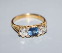 A 1970's Edwardian style 18ct gold, sapphire and diamond three stone ring, size N.