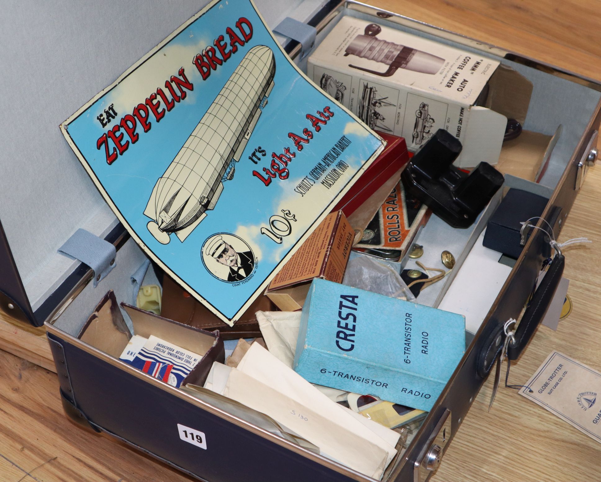 A vintage globetrotter case containing assorted ephemera to include glamour photo booklets, enamel