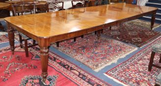 A late Victorian mahogany extending dining table on fine fluted tapered legs. Five spare leaves.