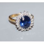 A modern 18ct gold, sapphire and diamond set oval cluster ring, size O.