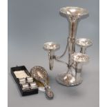 A plated four-trumpet epergne, a set of four silver napkin rings, cased and a silver-mounted brush