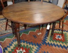 A 19th century French walnut circular drop leaf dining table 115cm diameter