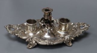 An ornate Victorian silver shaped oval inkstand, with taperstick, Birmingham,1842 and two later