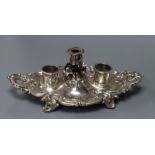 An ornate Victorian silver shaped oval inkstand, with taperstick, Birmingham,1842 and two later