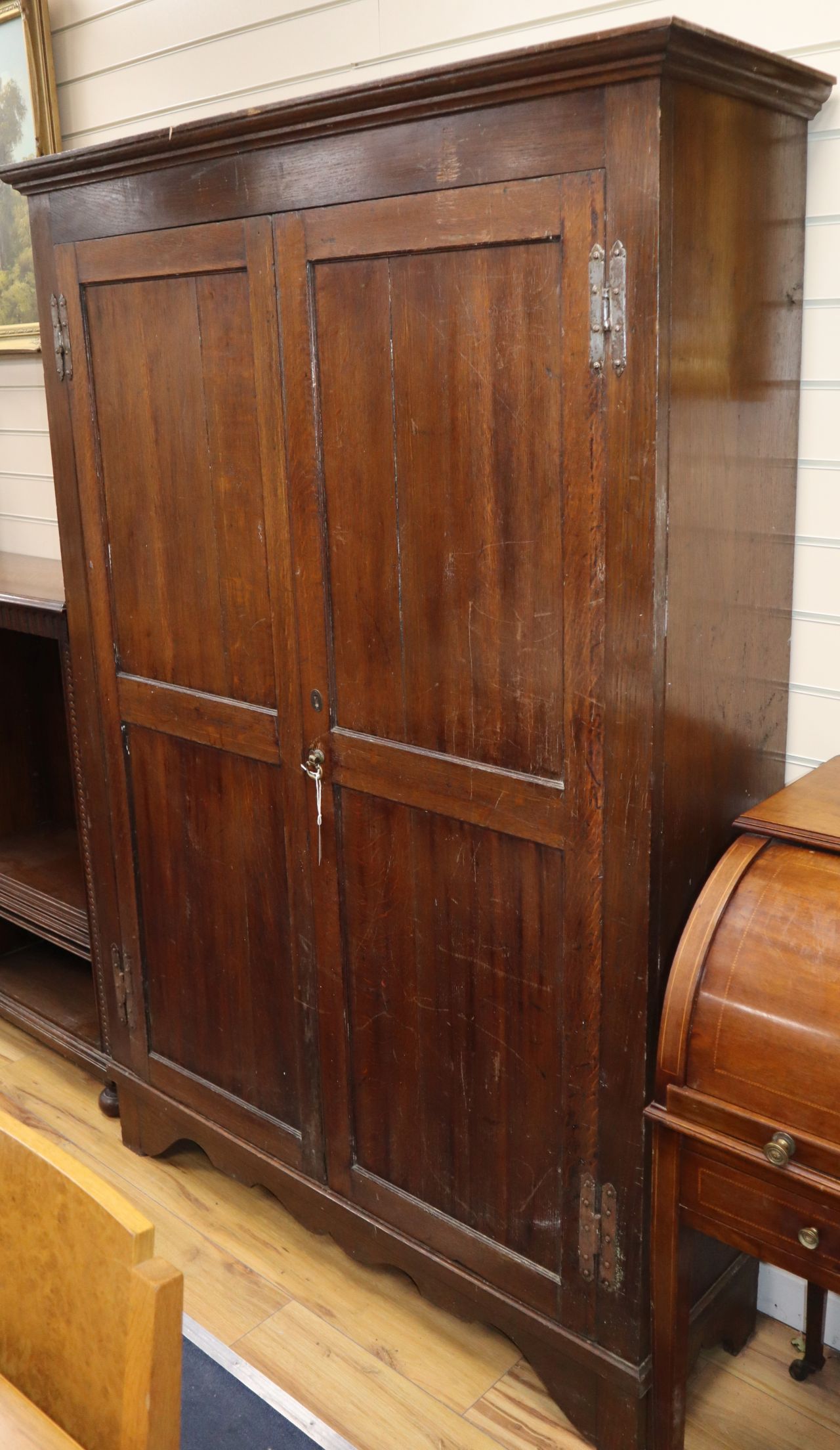 A 19th century and later panelled oak two door hall cabinet W.124cm