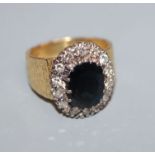 A 1960's textured 18ct gold, sapphire and diamond oval cluster ring, size L.