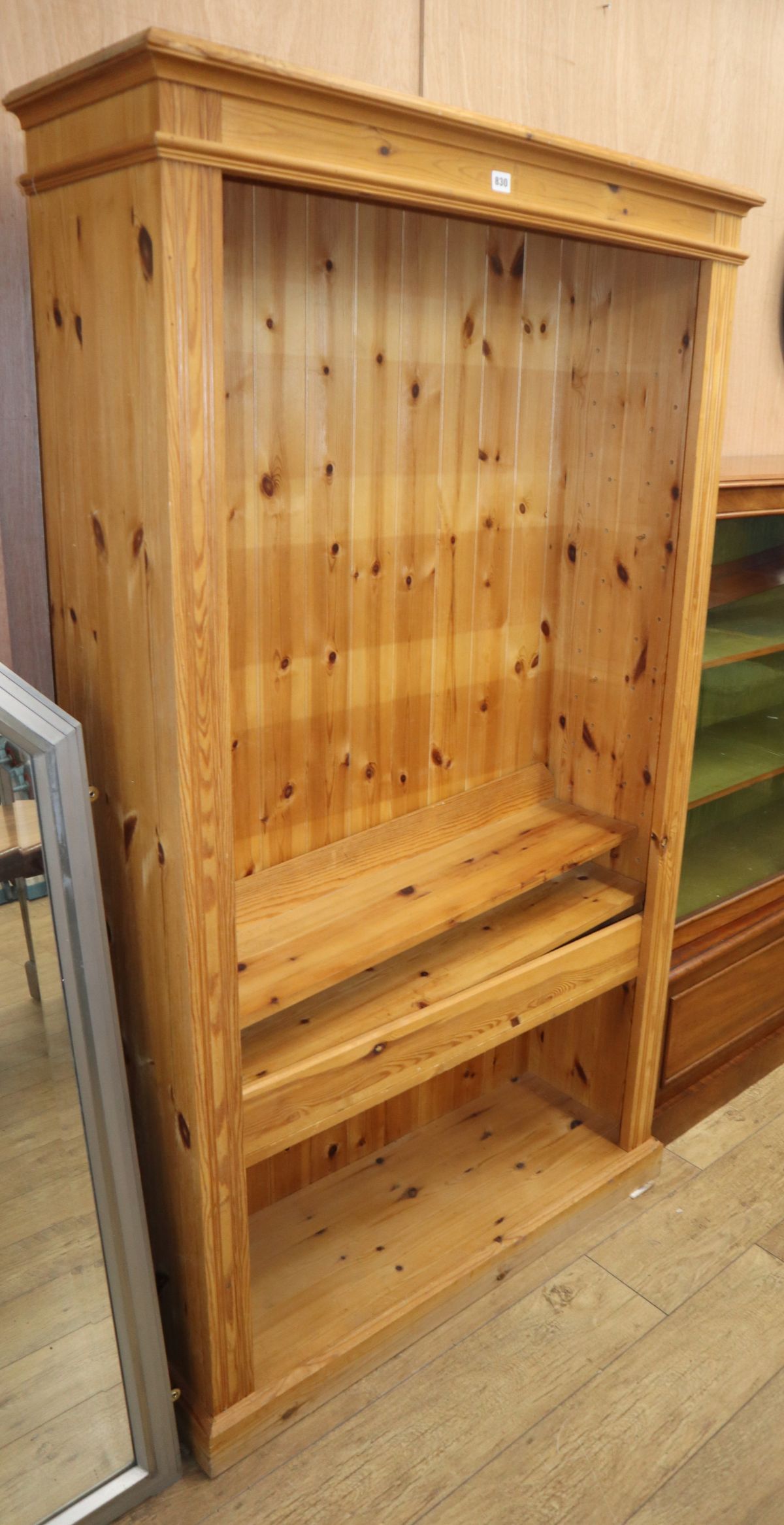 A reproduction pine open fronted bookcase W.103cm