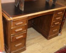 A 1920's oak pedestal desk W.135cm