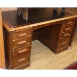 A 1920's oak pedestal desk W.135cm