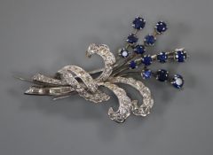 A white metal, sapphire and diamond set floral spray brooch, 48mm.