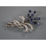 A white metal, sapphire and diamond set floral spray brooch, 48mm.