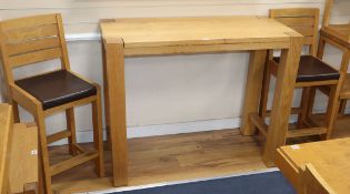 A contemporary oak high bar table and a pair of De La Espada oak bar chairs 120cm