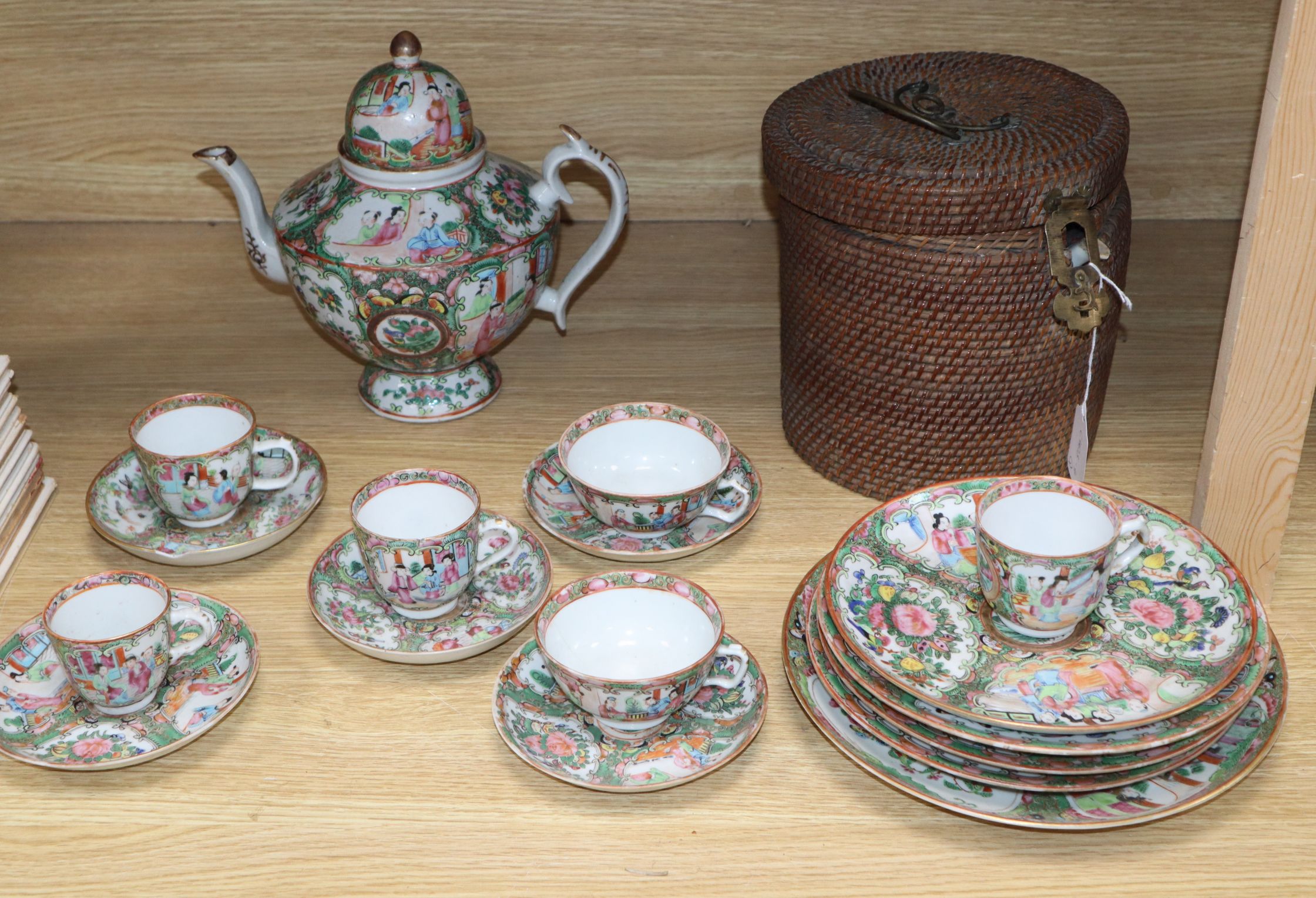 A group of 19th century Chinese famille rose tea wares including a teapot in a basket