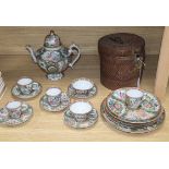 A group of 19th century Chinese famille rose tea wares including a teapot in a basket