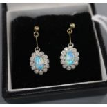 A pair of 9ct, black opal and diamond set oval cluster drop earrings, drop 18mm.