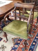 A pair of George III mahogany elbow chairs