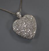 A modern pierced white metal and pave set diamond heart shaped pendant on an 18ct white gold fine