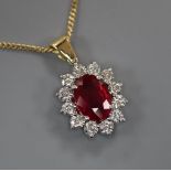 An 18ct gold and platinum ruby and diamond cluster pendant on 18ct gold fine chain, pendant 12mm.