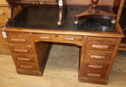 An early 20th century oak kneehole desk W.126cm