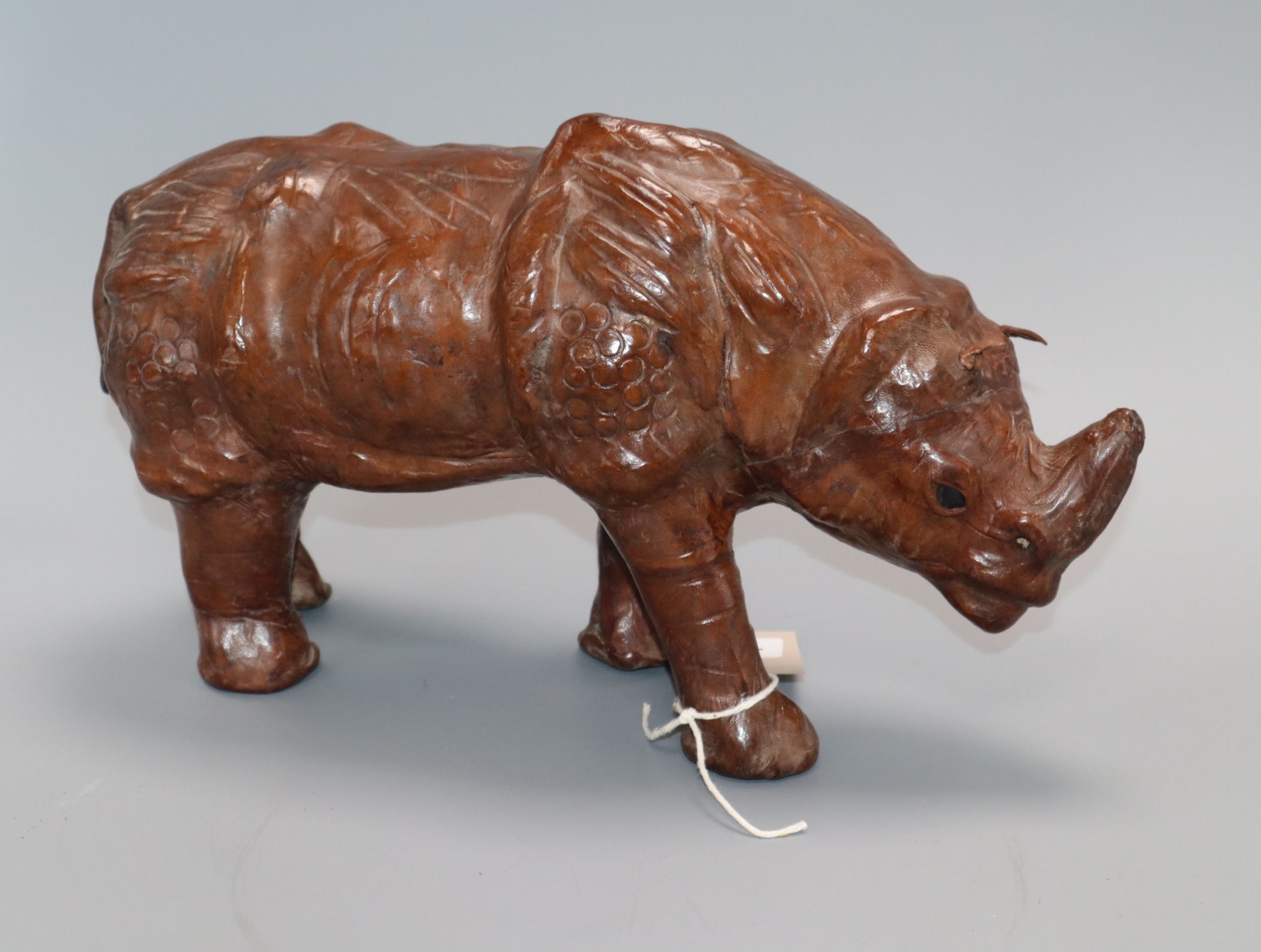 A leather model of a rhino bearing a stamped mark length 30cm approx.