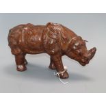 A leather model of a rhino bearing a stamped mark length 30cm approx.