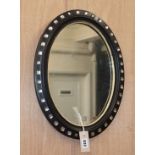 A small Irish style oval wall mirror H.45cm