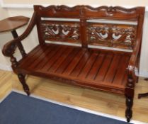 A reproduction carved hardwood bench W.120cm