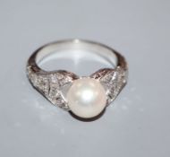 A modern 750 white metal, cultured pearl and diamond set dress ring, with pierced shoulders, size