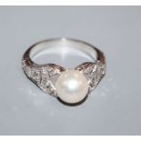 A modern 750 white metal, cultured pearl and diamond set dress ring, with pierced shoulders, size