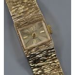 A lady's 1960's textured 9ct gold Accurist manual wind wrist watch, with spare link.