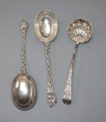 A George III silver later engraved and embossed sifter spoon and two Thai white metal preserve