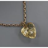 A heart shaped facetted citrine pendant, on an early 20th century 9ct chain, pendant 17mm.
