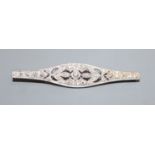 A 1920's pierced white metal and diamond set bar brooch, 54mm.