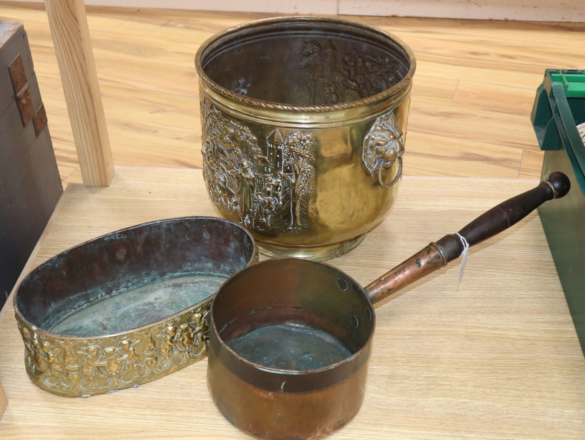 A 19th century oval embossed brass planter and an early copper pan and a Dutch brass log bin