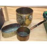 A 19th century oval embossed brass planter and an early copper pan and a Dutch brass log bin