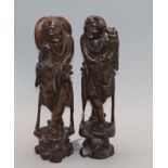 A pair of Chinese hardwood and wire figural carvings