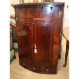 A George III mahogany bow front hanging corner cabinet W.86cm