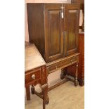 A 19th century oak two-door cupboard on later stand W.80cm